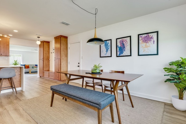 dining space with recessed lighting, visible vents, baseboards, and light wood finished floors