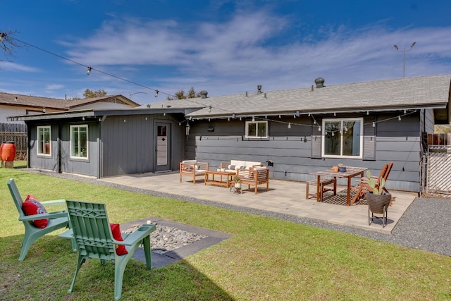 rear view of house with fence, a yard, a shingled roof, an outdoor hangout area, and a patio area