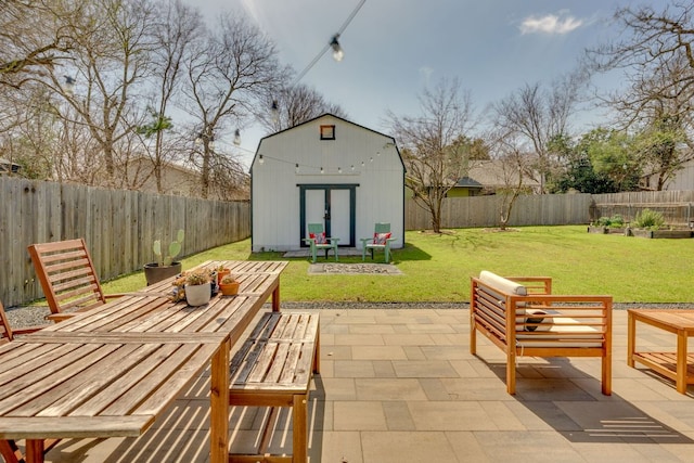 view of patio featuring an outdoor structure, a storage unit, and a fenced backyard