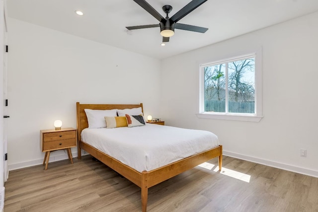 bedroom with recessed lighting, baseboards, and light wood-style flooring