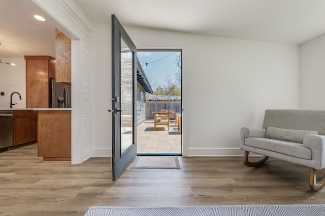 905 Turtle Creek Blvd, Austin, TX 78745 - doorway to outside featuring light wood-type flooring, baseboards, recessed lighting, french doors, and a sink