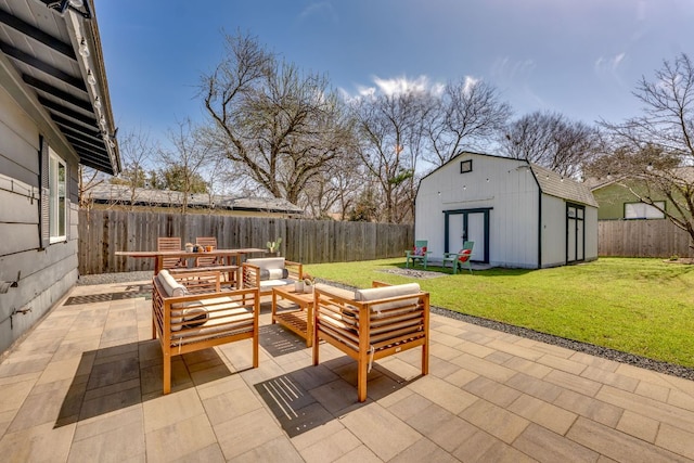 view of patio with a storage unit, an outdoor hangout area, an outbuilding, and a fenced backyard