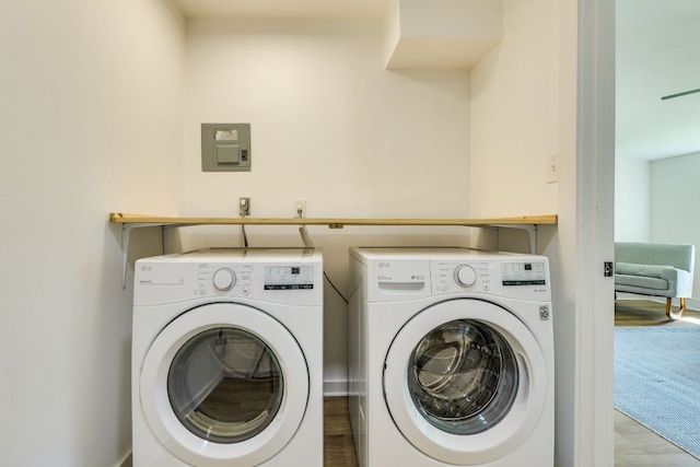 laundry area featuring wood finished floors, laundry area, and washing machine and clothes dryer