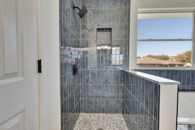 bathroom with tiled shower