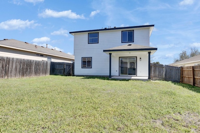 back of house featuring a fenced backyard and a yard