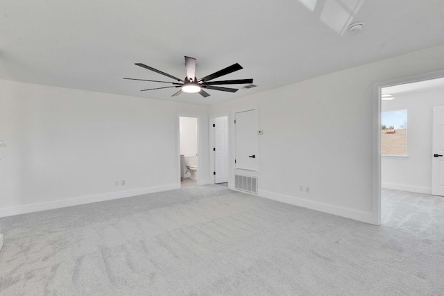 unfurnished room with baseboards and light colored carpet