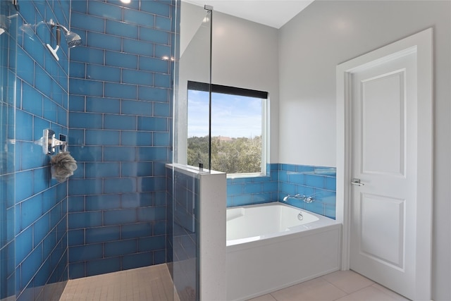 bathroom with tile patterned floors, a garden tub, and a walk in shower