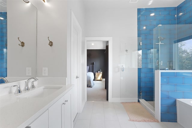 ensuite bathroom with vanity, tile patterned flooring, a shower stall, ensuite bathroom, and a washtub