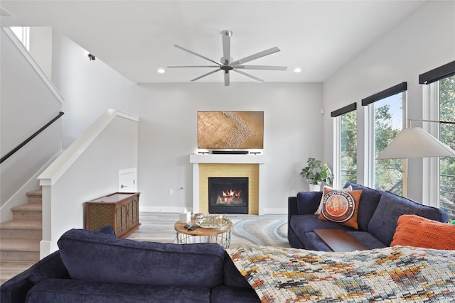 1503 Sharps Rd, Austin, TX 78734 - living room featuring wood finished floors, ceiling fan, recessed lighting, stairs, and a warm lit fireplace