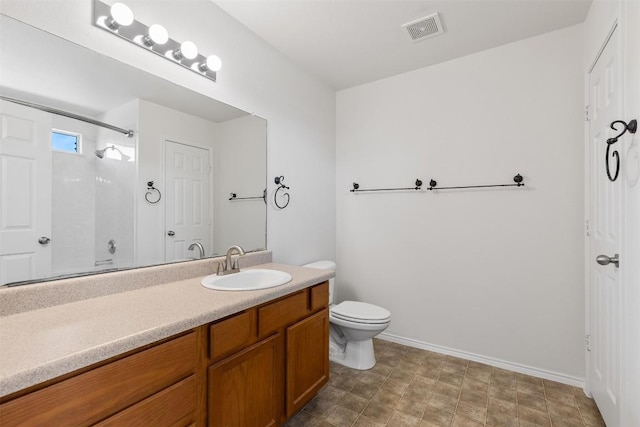 full bathroom featuring vanity, baseboards, visible vents, walk in shower, and toilet