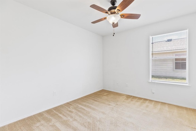 unfurnished room featuring light carpet and a ceiling fan