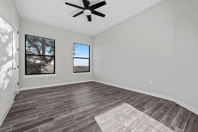 empty room with baseboards, wood finished floors, and a ceiling fan