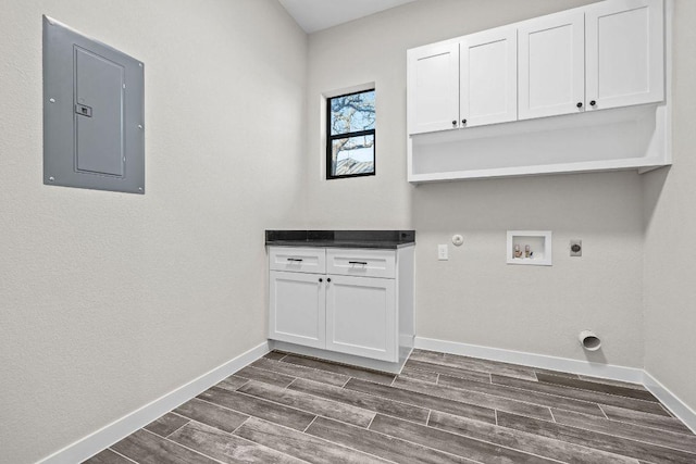 laundry area with wood finish floors, electric panel, hookup for a washing machine, hookup for a gas dryer, and electric dryer hookup