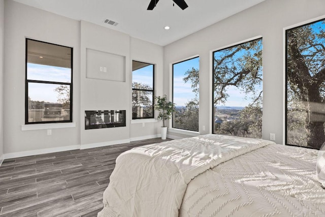 bedroom featuring recessed lighting, visible vents, baseboards, and wood finished floors