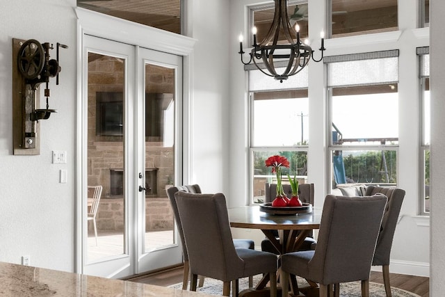 dining room featuring a notable chandelier, baseboards, and wood finished floors