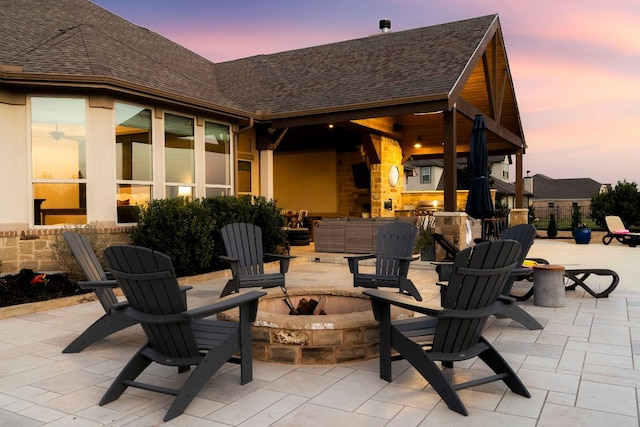 view of patio featuring a fire pit and fence