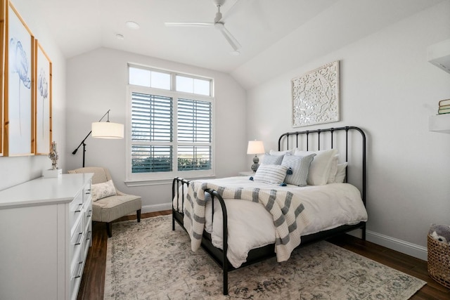 bedroom with baseboards, lofted ceiling, and wood finished floors