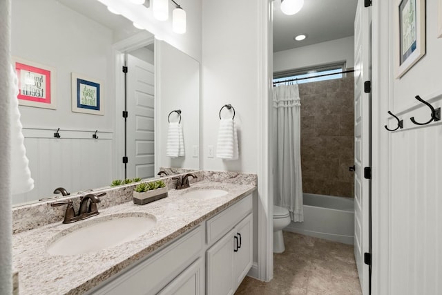 bathroom featuring a sink, toilet, shower / tub combo with curtain, and double vanity