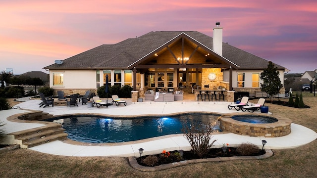 view of pool featuring a patio, outdoor dry bar, and a pool with connected hot tub