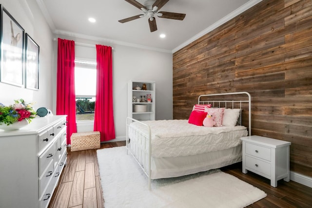 bedroom with recessed lighting, dark wood-type flooring, wood walls, and ornamental molding