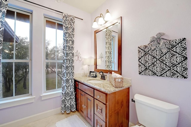 bathroom with tile patterned flooring, toilet, and vanity