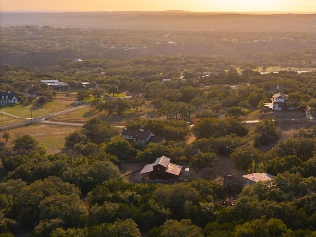 bird's eye view with a wooded view