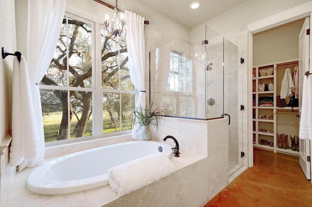 bathroom with plenty of natural light, a stall shower, and a walk in closet