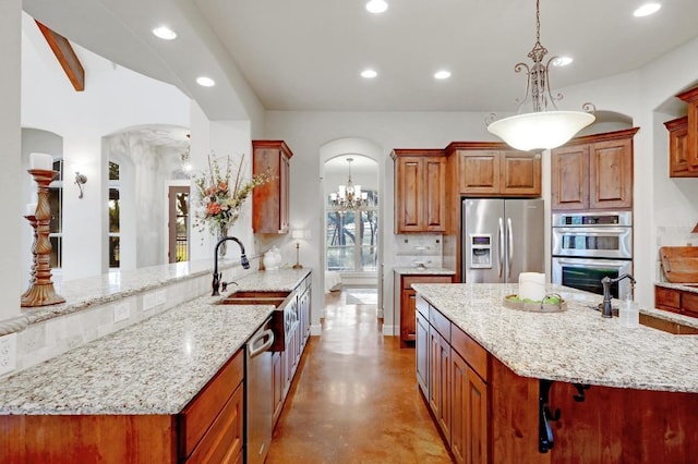 kitchen with a sink, arched walkways, and stainless steel appliances