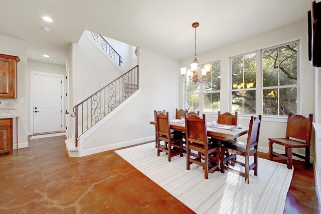 dining room featuring stairway, a notable chandelier, a healthy amount of sunlight, and baseboards