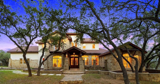 mediterranean / spanish home with stucco siding and stone siding