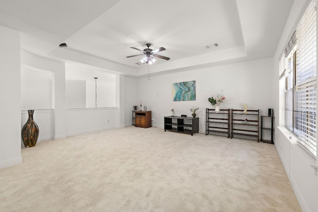 sitting room featuring a raised ceiling, carpet, and visible vents