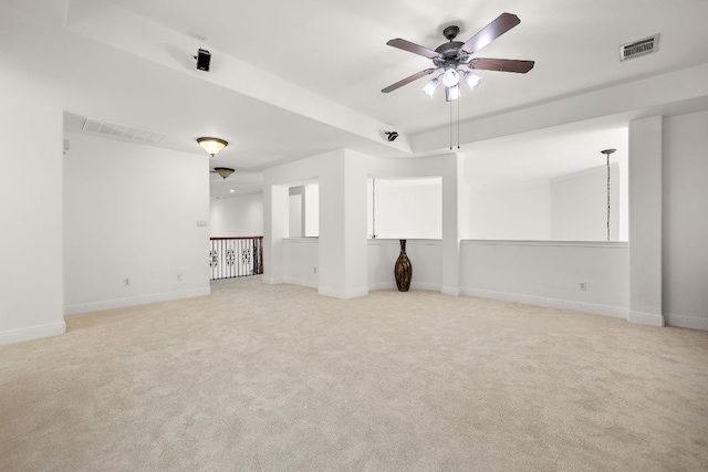 unfurnished living room featuring light carpet, visible vents, and baseboards