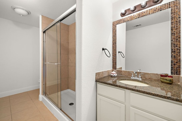 full bathroom featuring tile patterned floors, visible vents, a stall shower, and vanity