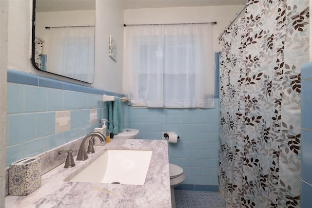 full bath with tile patterned flooring, tile walls, toilet, a shower with curtain, and vanity