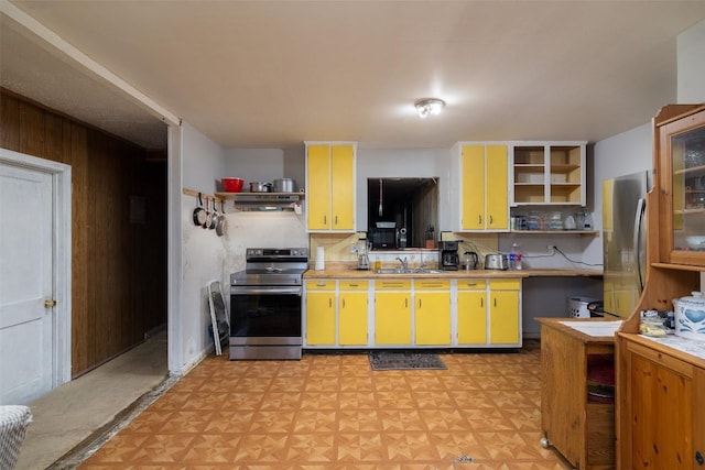 kitchen featuring a sink, appliances with stainless steel finishes, light countertops, and open shelves