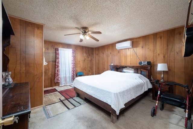 bedroom with wood walls, a textured ceiling, an AC wall unit, and carpet floors