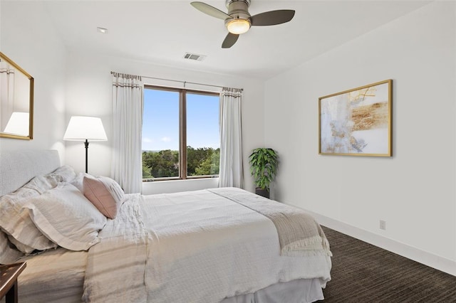 carpeted bedroom with visible vents, a ceiling fan, and baseboards