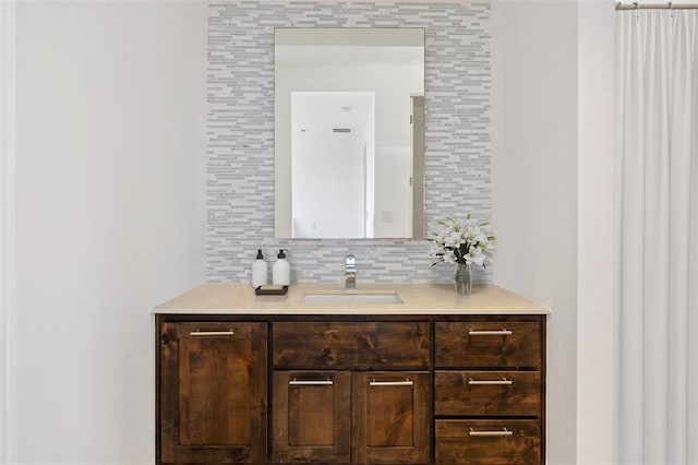 bathroom featuring vanity and tasteful backsplash