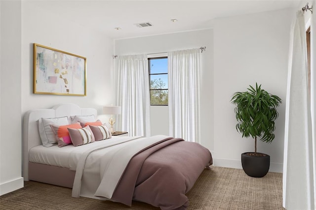 bedroom with visible vents, baseboards, and carpet