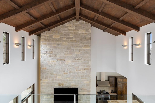 interior space featuring beam ceiling, wood ceiling, and wall chimney exhaust hood