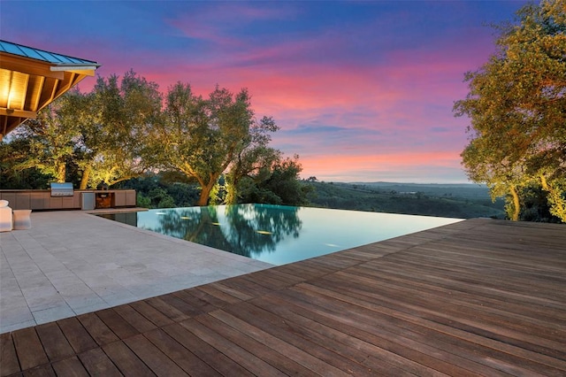 view of pool featuring area for grilling