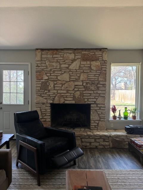 living area with wood finished floors and a fireplace