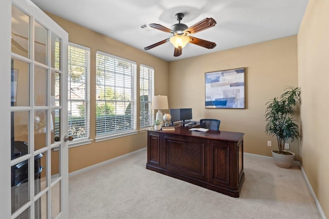 home office with light carpet, french doors, a ceiling fan, and baseboards