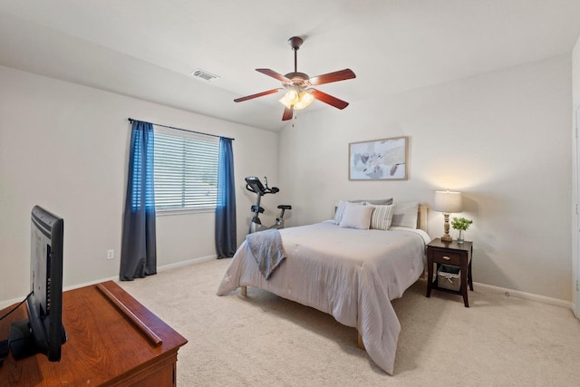 bedroom featuring light carpet, visible vents, a ceiling fan, and baseboards