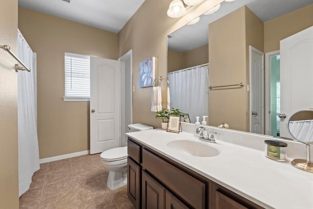 full bath featuring tile patterned flooring, toilet, vanity, and baseboards