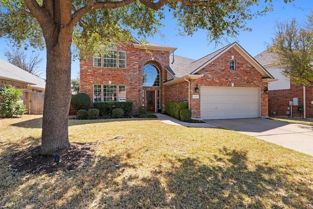 traditional-style home featuring fence, concrete driveway, a front yard, a garage, and brick siding