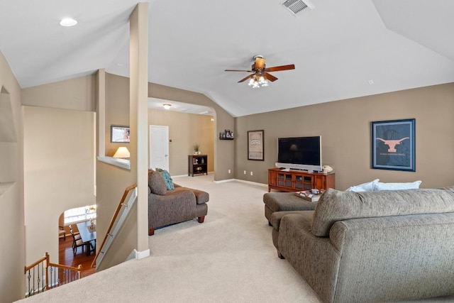 living room with visible vents, a ceiling fan, baseboards, light colored carpet, and vaulted ceiling