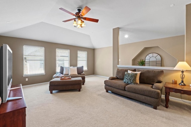 carpeted living room with vaulted ceiling, a ceiling fan, and baseboards