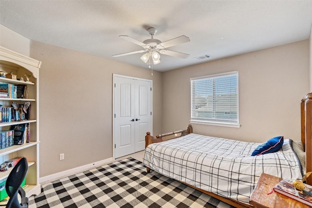 bedroom featuring a ceiling fan, baseboards, visible vents, and a closet