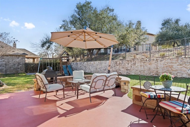 view of patio / terrace featuring a playground, outdoor dining area, and a fenced backyard